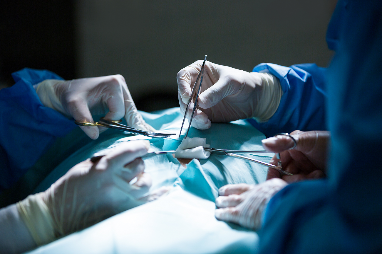 surgeons performing surgery on a patient